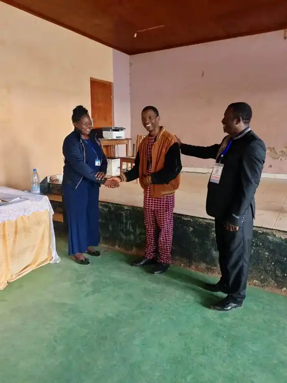 Showing the PF to the pastor of Gentleman Living church Ndu